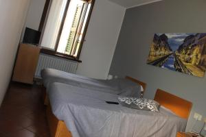 Un pat sau paturi într-o cameră la ALBERGO LA SCALETTA