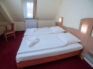 Postel nebo postele na pokoji v ubytování Johanniterhotel