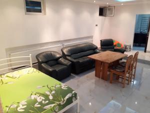 a living room with a couch and a table at Park Puscha Sauna Deluxe Apartment & Terrace in Kyiv