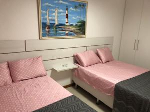 a bedroom with two beds and a lighthouse at Luxury 3 Bedroom Apartment - Barra in Salvador