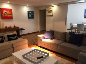 a living room with a couch and a table at Luxury 3 Bedroom Apartment - Barra in Salvador