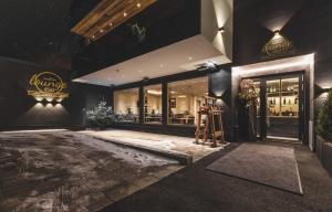 a store front of a restaurant at night at Residenz Gramaser GmbH in Ischgl