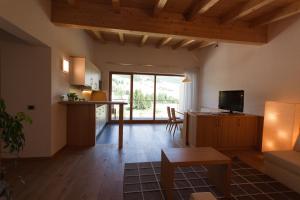 a living room with a kitchen and a dining room at Antorè in Badia