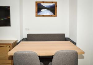 a conference room with a wooden table and two chairs at Bergruh Steeg in Steeg