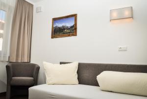 a living room with a couch and a chair at Bergruh Steeg in Steeg