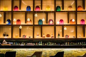 a room with shelves filled with different colored vases at Kenzi Tower Hotel in Casablanca