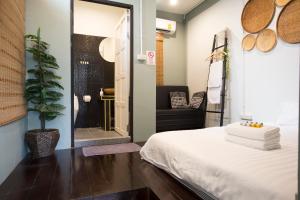 a room with a bed and a bathroom with a shower at The Orientale Hostel in Bangkok +24 photos