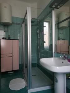 a bathroom with a sink and a glass shower at Il Vostro Comfort in Rome