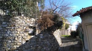 a stone wall in front of a house at Alloggio Basilico in Diano San Pietro