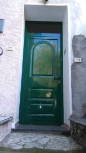 a green door with a window in a building at Alloggio Basilico in Diano San Pietro