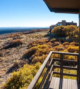 a view from the porch of a house with a wooden walkway at Far View Lodge in Mesa Verde National Park