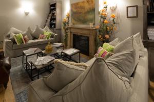 a living room with a couch and a fireplace at Il Duomo Luxury Suite in Pietrasanta