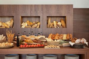 a display of bread and pastries on a table at Romance Alexandria Hotel in Alexandria