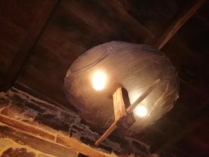 a light hanging from the ceiling of a building at Apartamentos rurales Casa Do Cabo in Vega de Logares