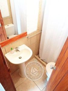 a bathroom with a sink and a toilet at Complejo Los Girasoles in Punta Del Diablo