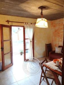 a living room with a table and a glass door at Complejo Los Girasoles in Punta Del Diablo