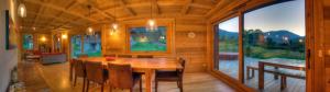 a wooden dining room with a wooden table and chairs at CHALET CHAM'ROCK in Les Houches +6 photos