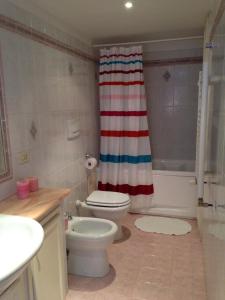 a bathroom with a red white and blue shower curtain at A CASA DI ZIA LOLA in Rome