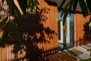 a shadow of a tree on the side of a building at Hypnos Boutique Hotel in Nicosia