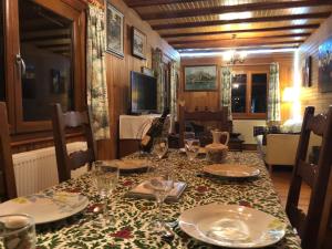 a dining table with plates and glasses on it at Chalet Braunkopf ALSACE in Muhlbach-sur-Munster