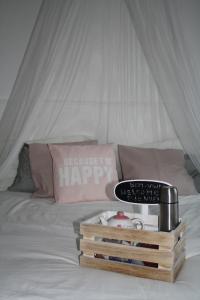 a bed with a white bedspread with a tray of items at Casa de férias Josefa D´Óbidos in Óbidos