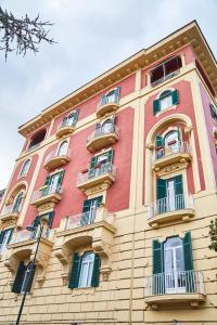 a tall building with balconies on the side of it at Suite Klimt P.zza Amedeo in Naples