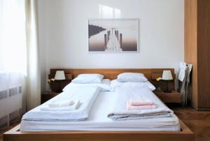 a bedroom with two beds with towels on them at City Castle Aparthotel in Prague