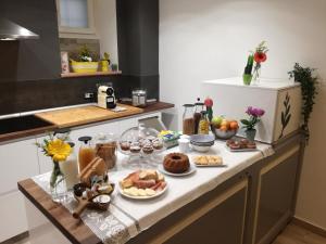 a table with food on it in a kitchen at B&B Casa Lilli in Foligno