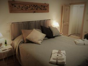 a bedroom with a bed with a towel on it at B&B Casa Lilli in Foligno