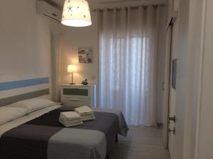 a bedroom with a bed with two towels on it at Casa Vacanza Anna Maria in Porto Cesareo