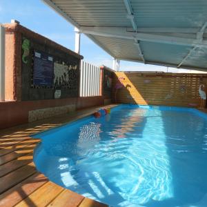 a swimming pool on a deck with a slide at Villas y Suites Paraiso del Sur in Cuernavaca