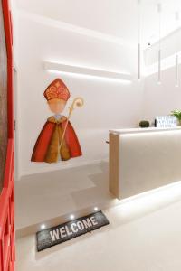a kitchen with a welcome sign on the floor next to a refrigerator at A Misura Duomo Rooms & Apartment - LS Accommodations in Naples