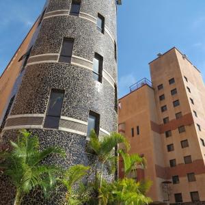 a building with a mosaic facade with two buildings at Villas y Suites Paraiso del Sur in Cuernavaca
