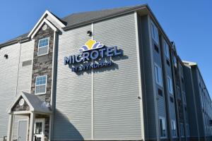 a exterior view of a microsoft sign on the side of a building at Microtel Inn & Suites by Wyndham Carlisle in Carlisle