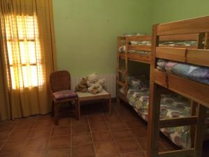 a teddy bear sitting on a table in a room with bunk beds at Cal Cabrer - El Vilosell in El Vilosell