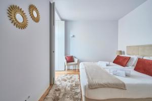 a bedroom with two beds and a mirror on the wall at Casa Portuguesa Ouro in Lisbon