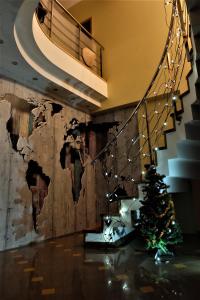 a christmas tree in a room with a staircase at A&L private rooms in Kaunas in Kaunas