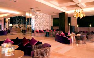a hotel lobby with couches and tables and a chandelier at ROYAL BEACH HOTEL apartment in Sunny Beach