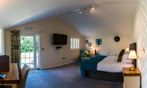 a bedroom with a bed and a couch and a tv at Manor Court Hotel in Bridlington