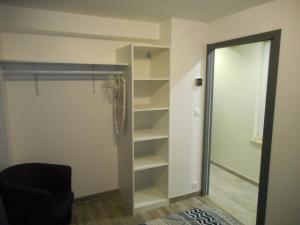 a walk in closet with a sliding glass door at GITE DE LA PECHERIE in Saint-Aignan