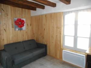 a living room with a couch and a window at GITE DE LA PECHERIE in Saint-Aignan