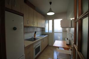 a kitchen with a sink and a stove at Apartamento BENIMUR 3 in Cobatillas