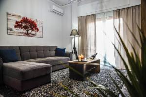 a living room with a couch and a coffee table at Luxury apartment near Acropolis! in the Heart of Athens! in Athens