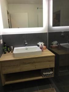 bagno con lavandino bianco e specchio di Haus Schladming a Schladming