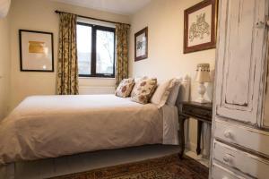 a bedroom with a white bed and a window at Dilkara Apartment Glastonbury in Glastonbury