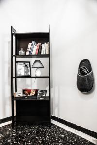 a book shelf with a lamp and a hat on a wall at Luxury apartment near Acropolis! in the Heart of Athens! in Athens