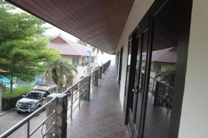 a balcony with a car parked on a street at Tommy Resort in Haad Rin
