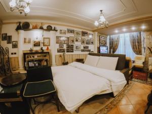 a bedroom with a large white bed and a fireplace at DB Apartment in Tirana
