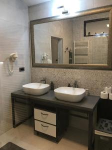 a bathroom with two sinks and a large mirror at Grey apartment Zagreb in Zagreb