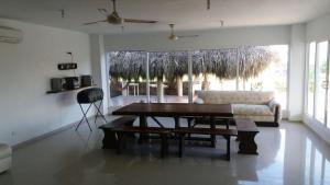 a living room with a table and a couch at Cabaña Villa Flower Gold in Juan de Acosta